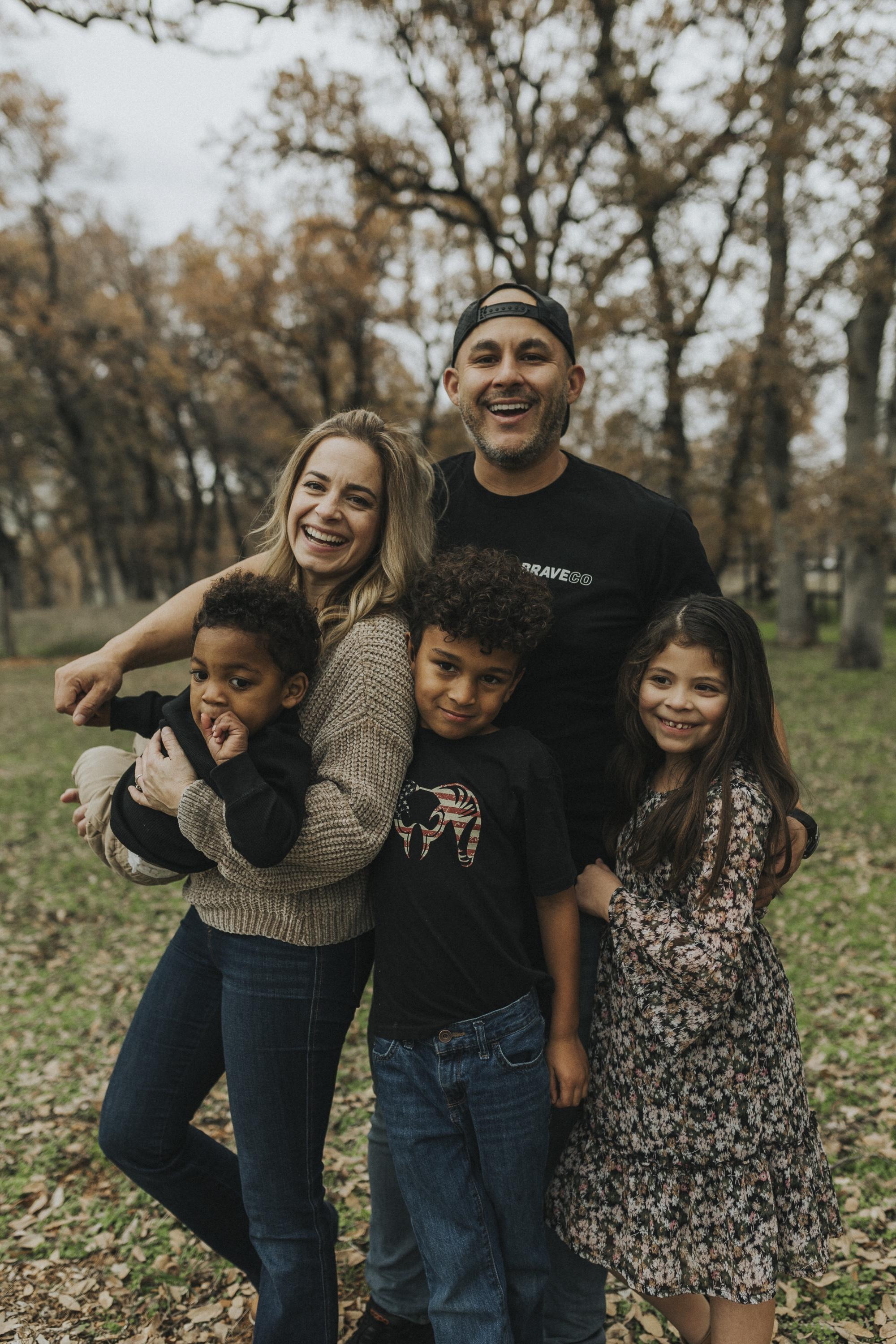 Chris Lamm laughing outside with his wife and three children