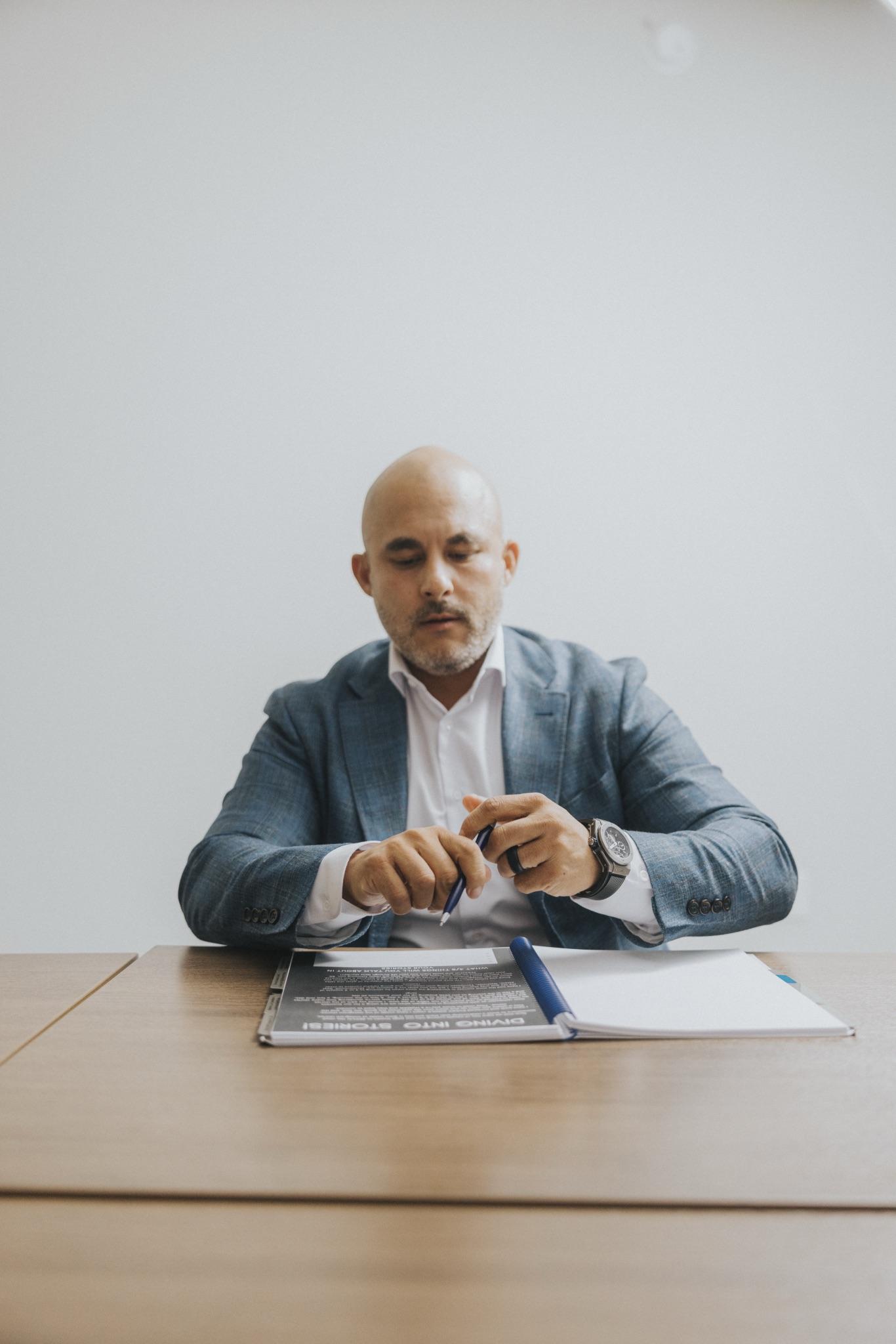 Chris Lamm reviewing loan documents at his desk in Redding, California