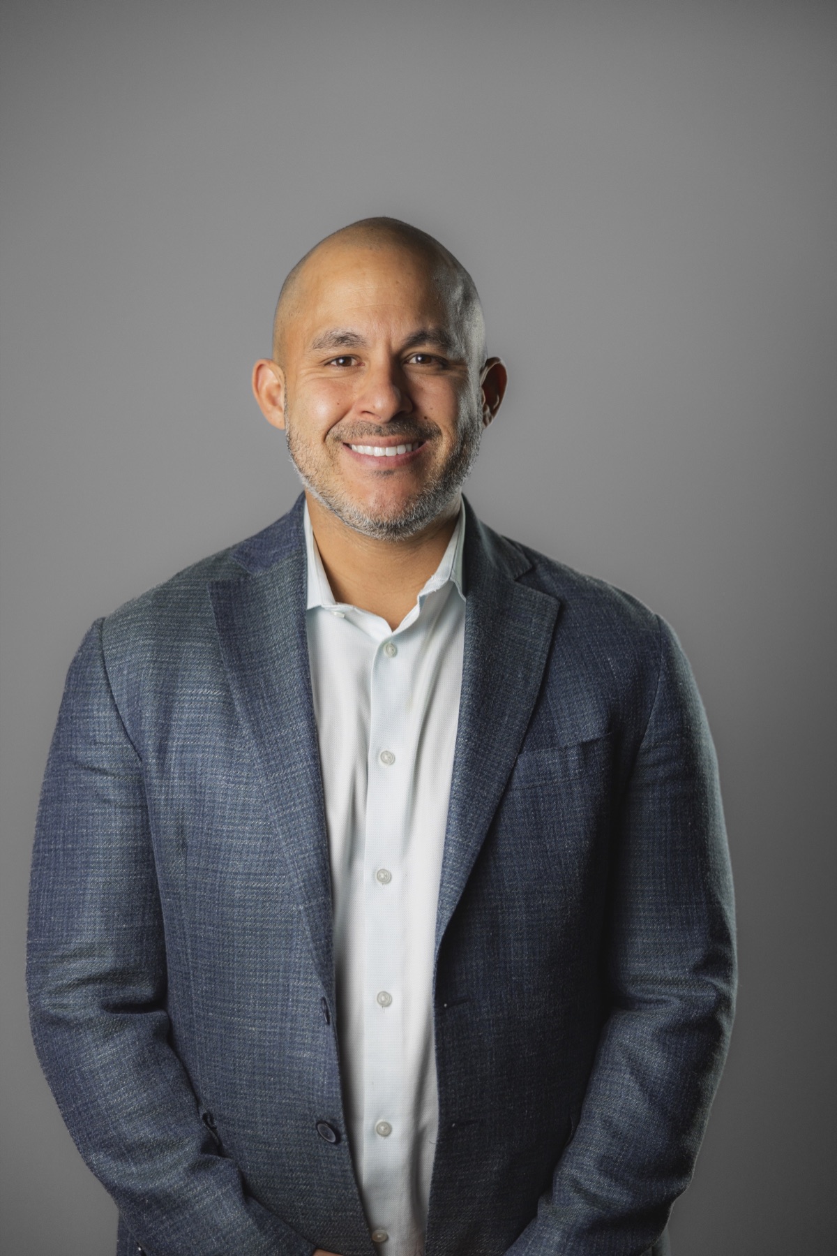 Chris Lamm smiling in a blue suit jacket
