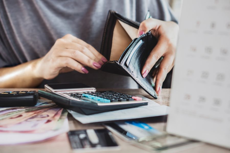 struggling with debt looking into an empty wallet