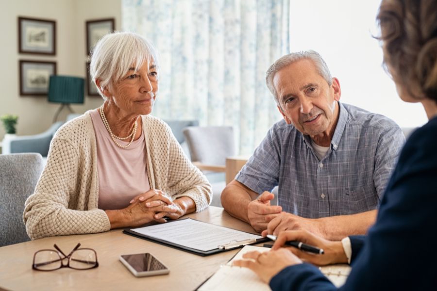 An elderly couple discussing a reverse mortgage with Chris Lamm, a mortgage advisor in Redding